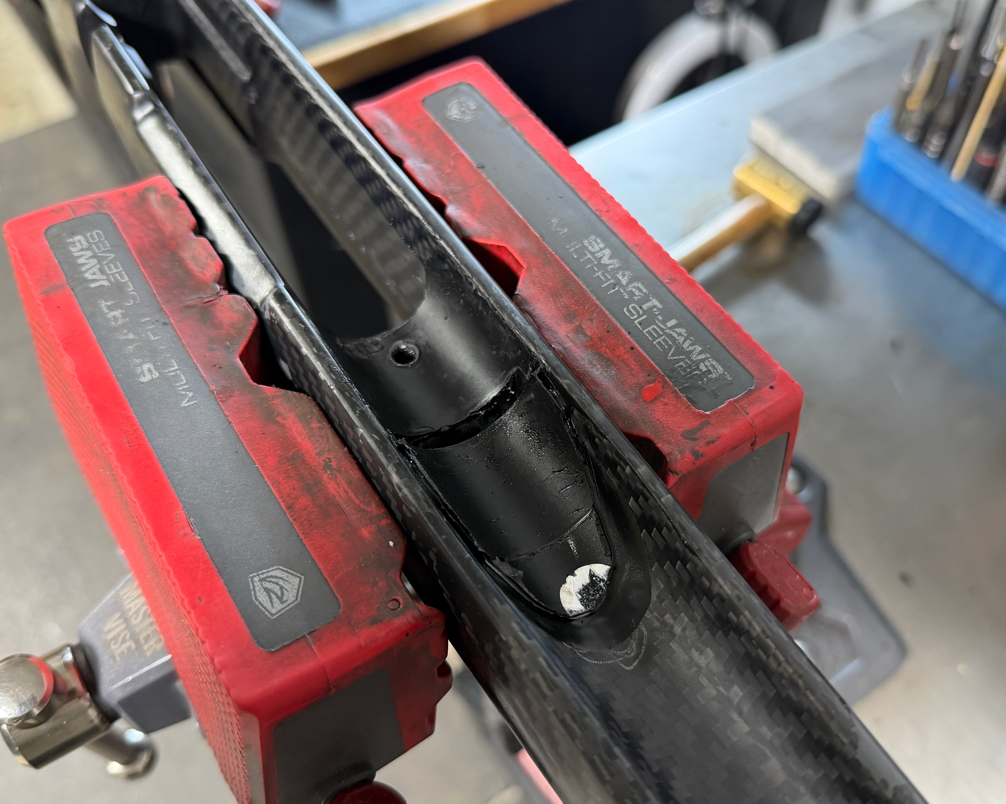 Carbon fiber barrel secured in Smart Jaws vise blocks during barrel installation — precision gunsmithing work at Northwoods Firearms, Crandon, WI