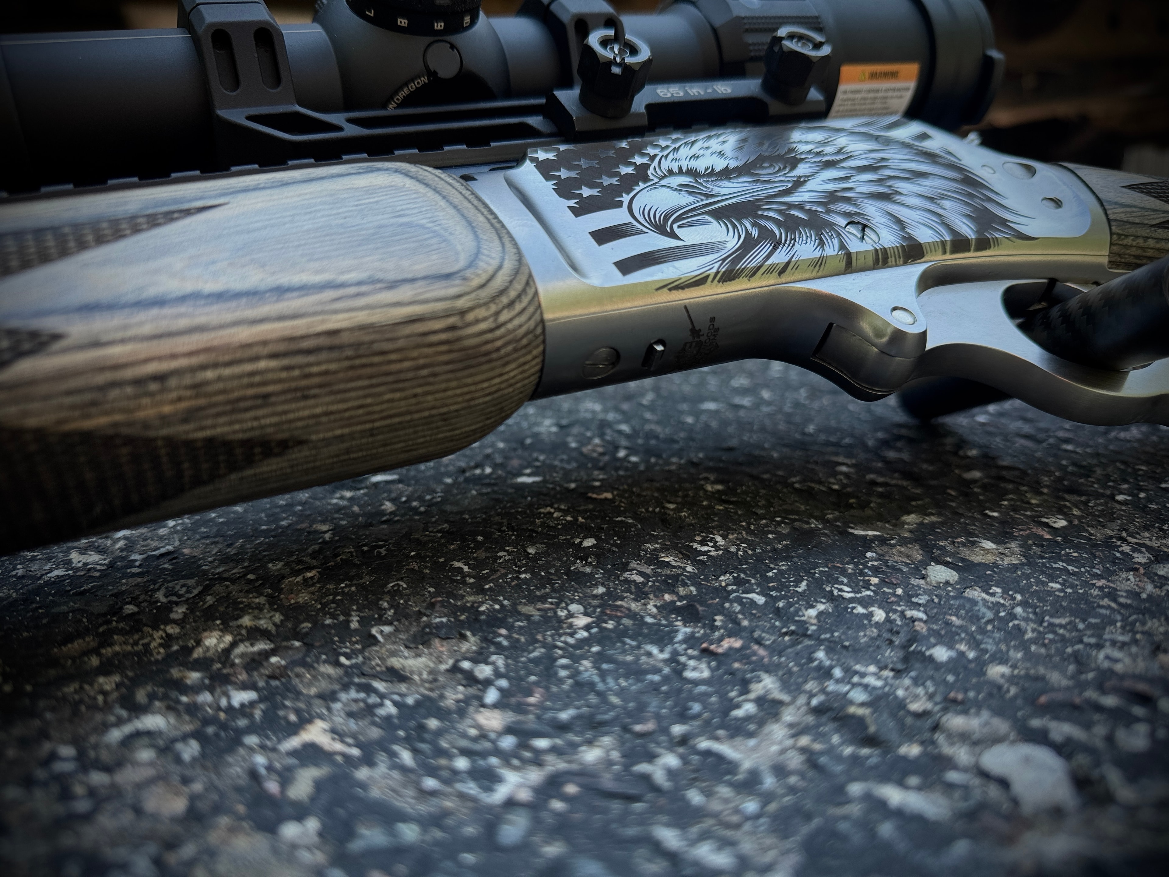Lever-action rifle receiver with laser-engraved American bald eagle and US flag — OD green Cerakote chassis and laminate stock — by Northwoods Firearms
