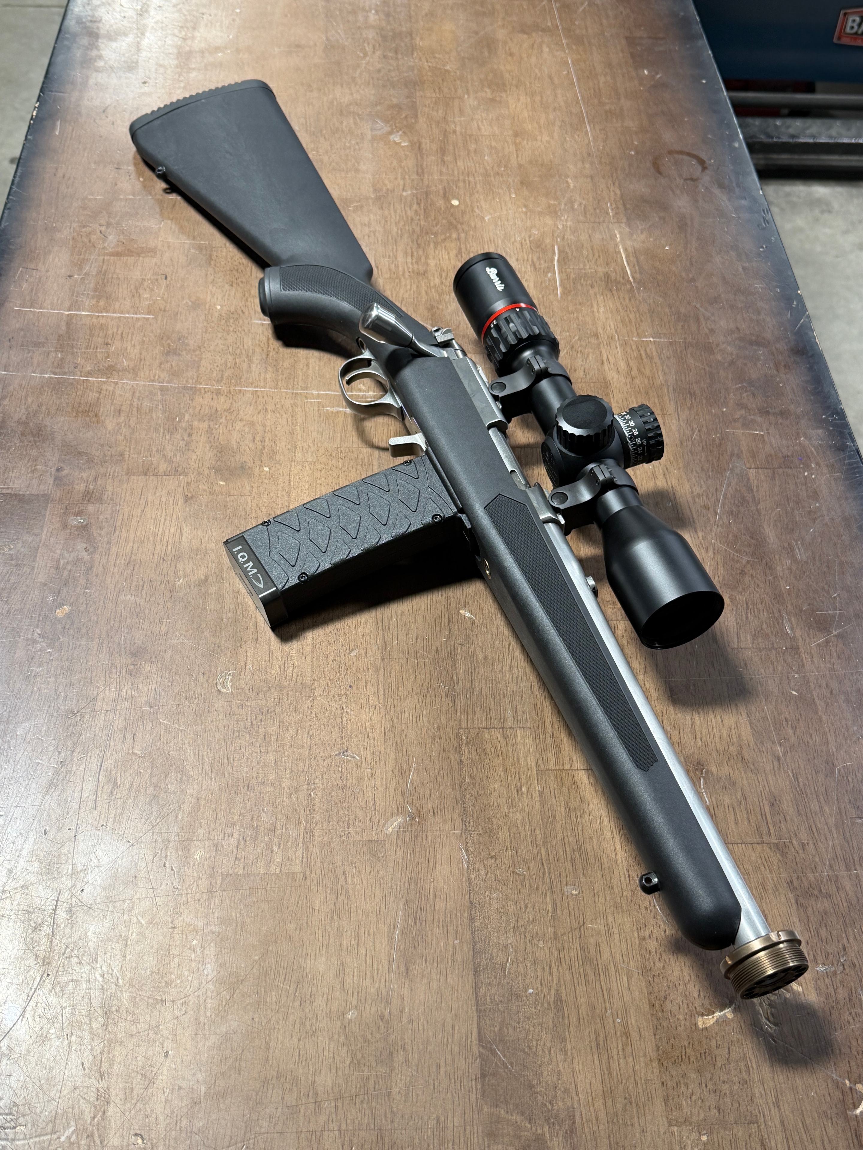 Custom Ruger Precision Rimfire build with Burris scope, threaded barrel, and extended magazine — completed on the workbench at Northwoods Firearms, Crandon, WI