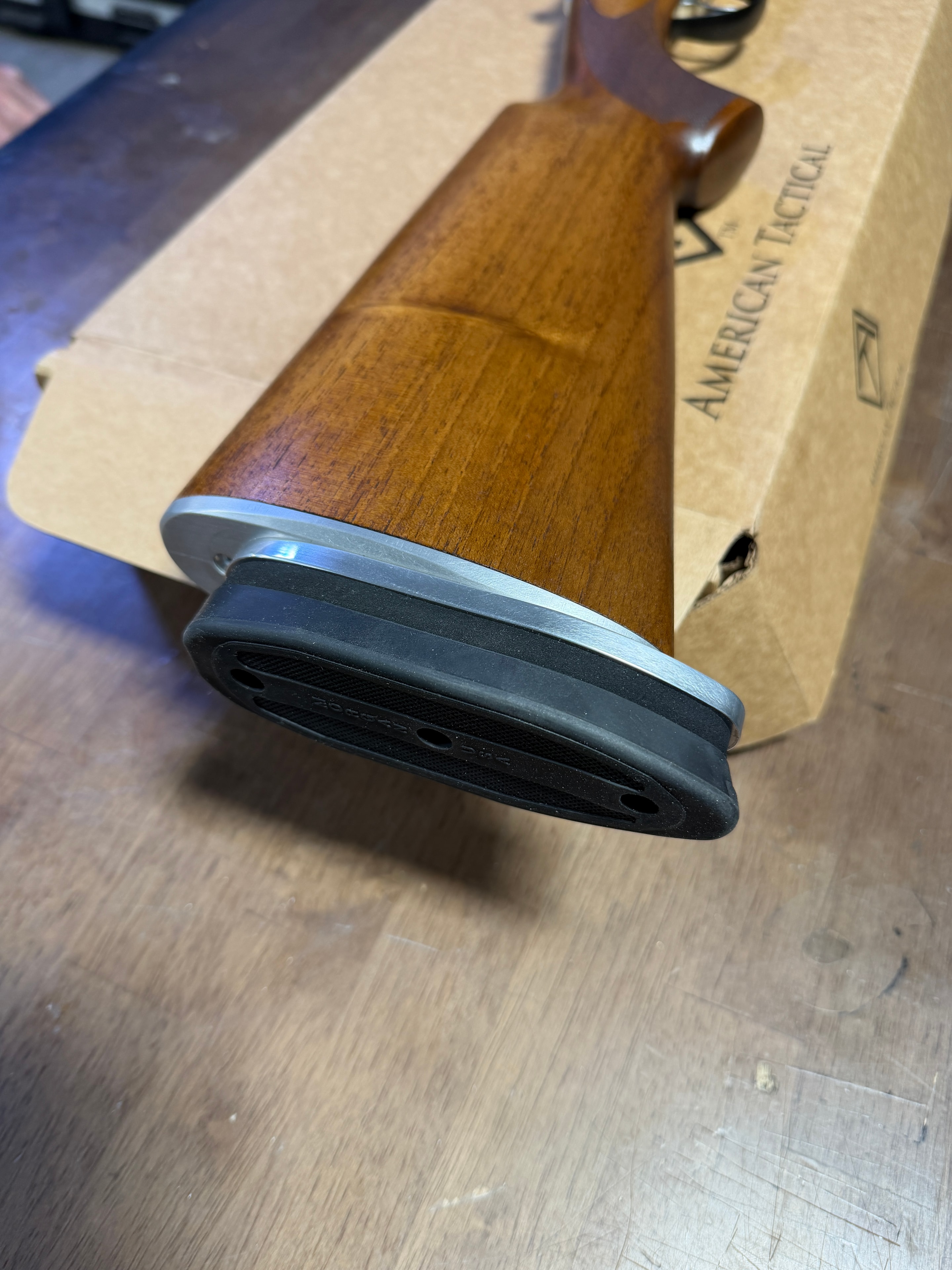 Custom walnut rifle stock with precision-fit aluminum spacer and Pachmayr recoil pad — hand-fitted stock work at Northwoods Firearms, Crandon, WI