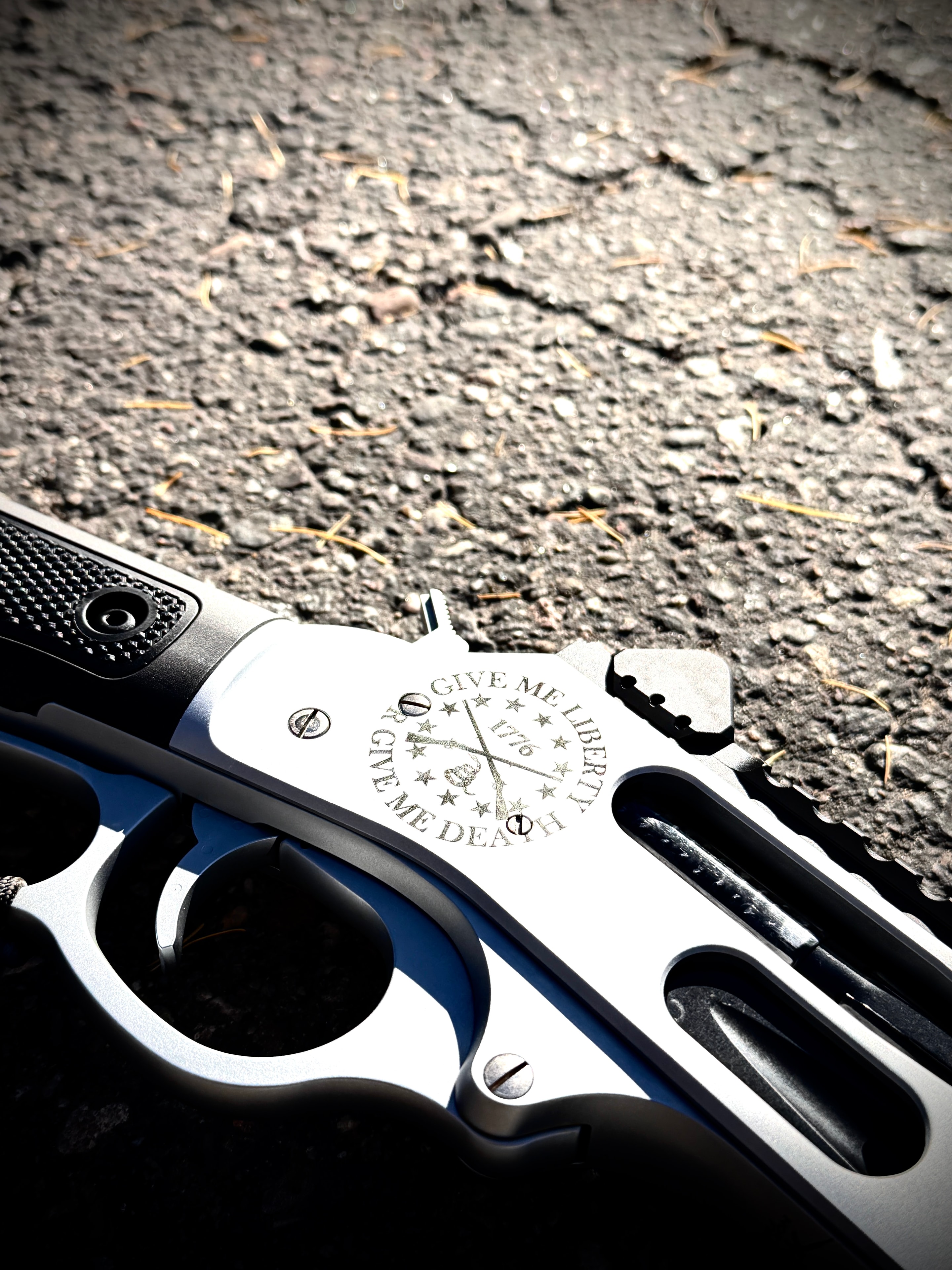 Close-up of laser-engraved 1911 pistol frame — Give Me Liberty or Give Me Death, 1776, crossed muskets medallion — by Northwoods Firearms, Crandon, WI