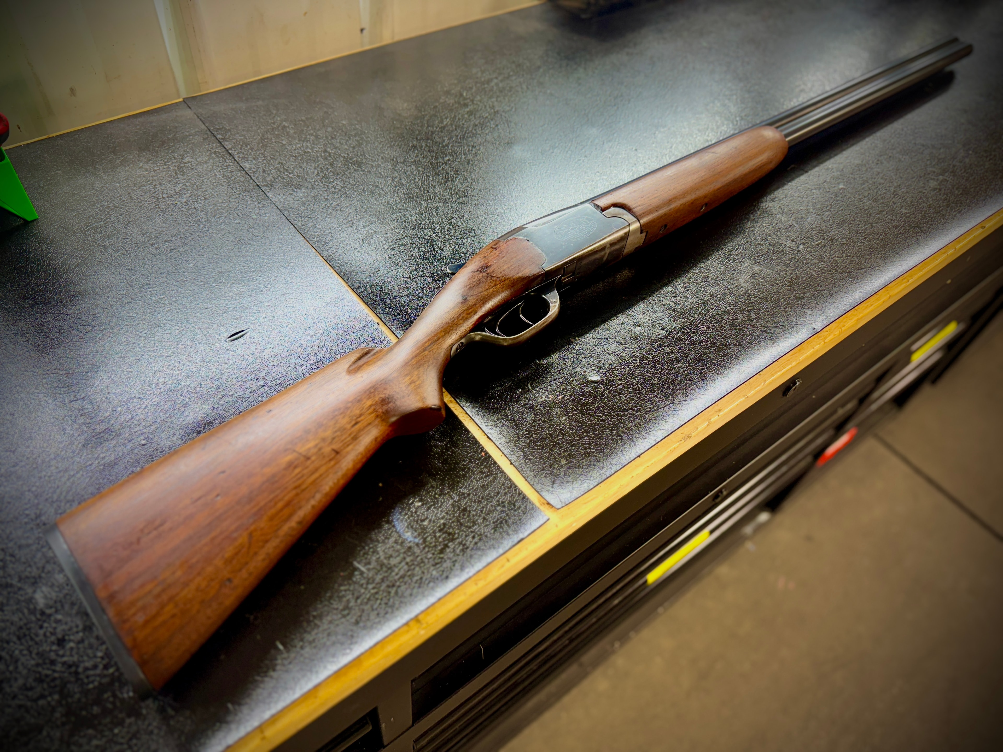 Restored Browning Auto-5 semi-automatic shotgun — full profile on workbench showing refinished walnut stock and reblued receiver — by Northwoods Firearms