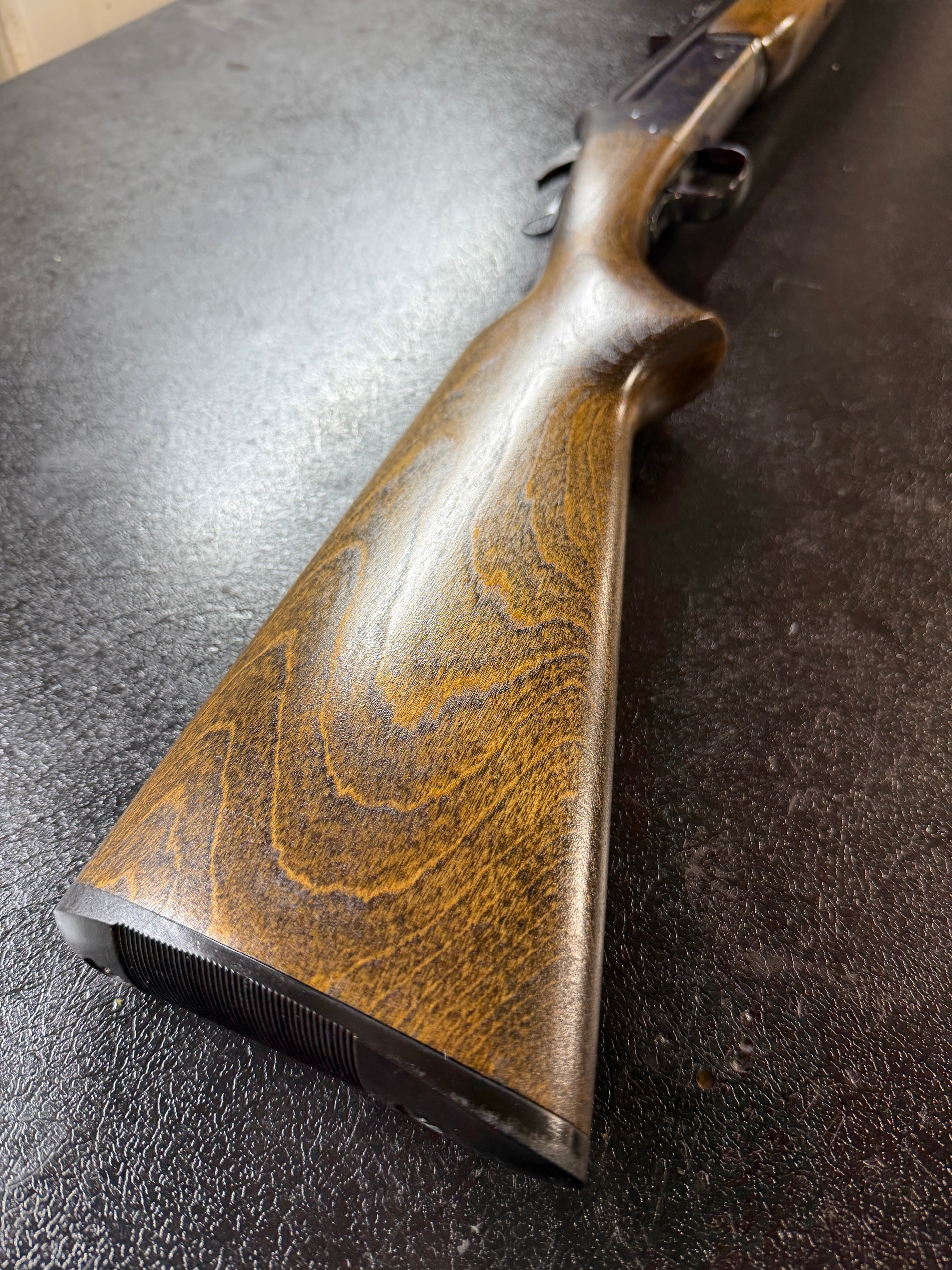 Beautifully refinished figured walnut buttstock with deep oil finish highlighting the natural grain and figure — full restoration by Northwoods Firearms, Crandon, WI