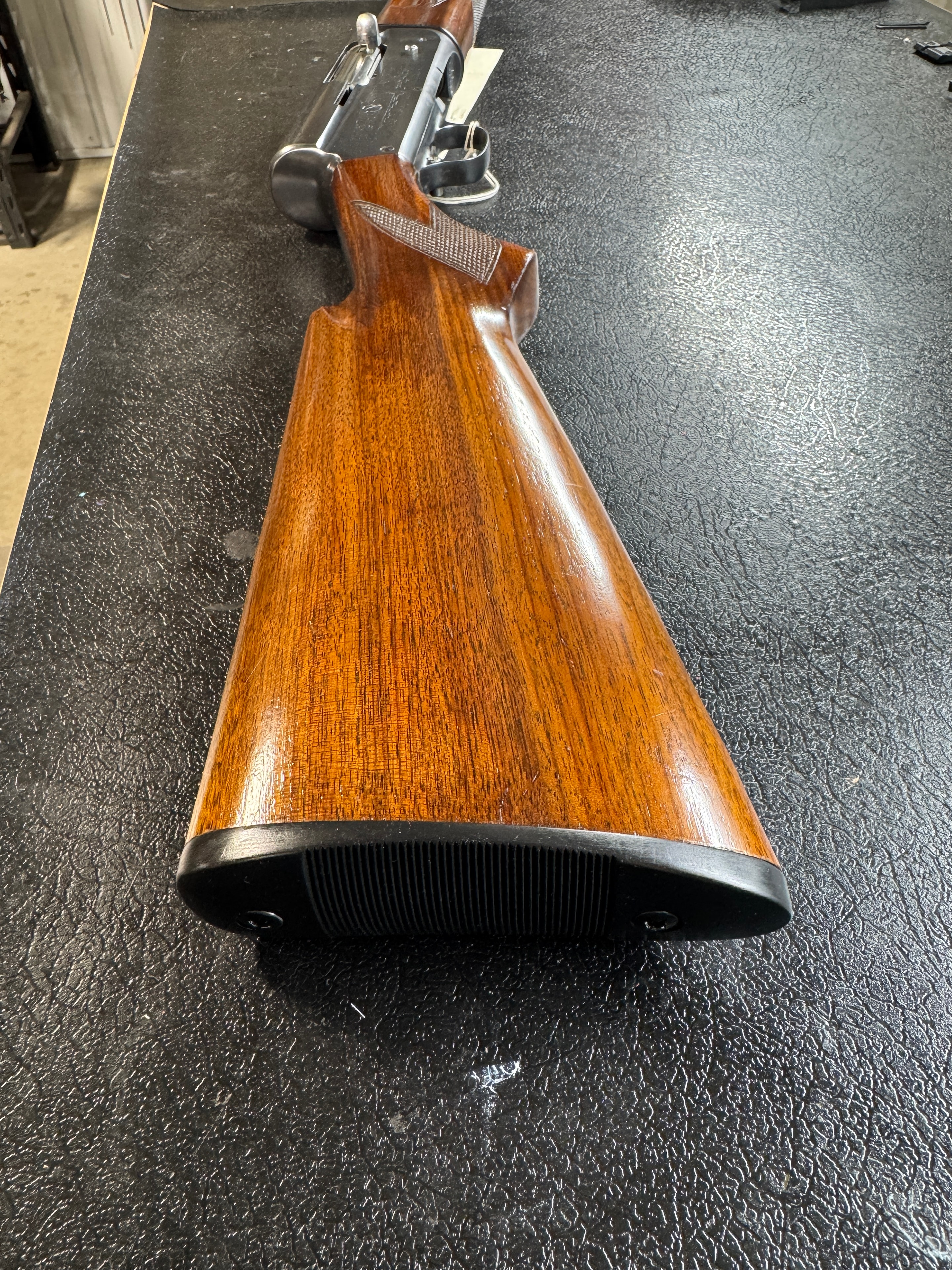 Vintage rifle butt stock restoration — refinished straight-grain walnut with recoil pad, showing clean wood grain — by Northwoods Firearms, Crandon, WI