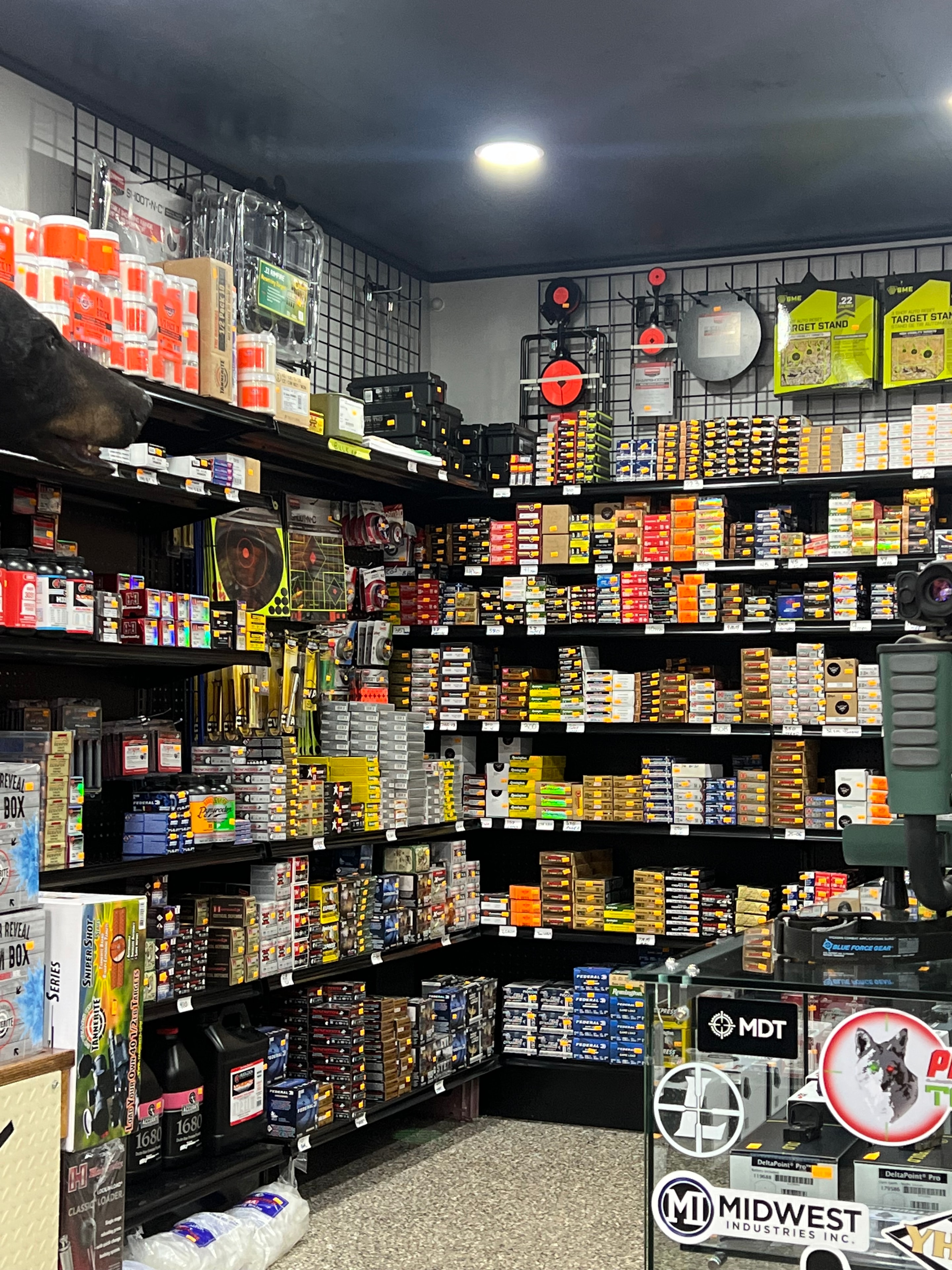 Northwoods Firearms ammo display — hundreds of boxes of ammunition in every caliber, MDT and Midwest Industries signage