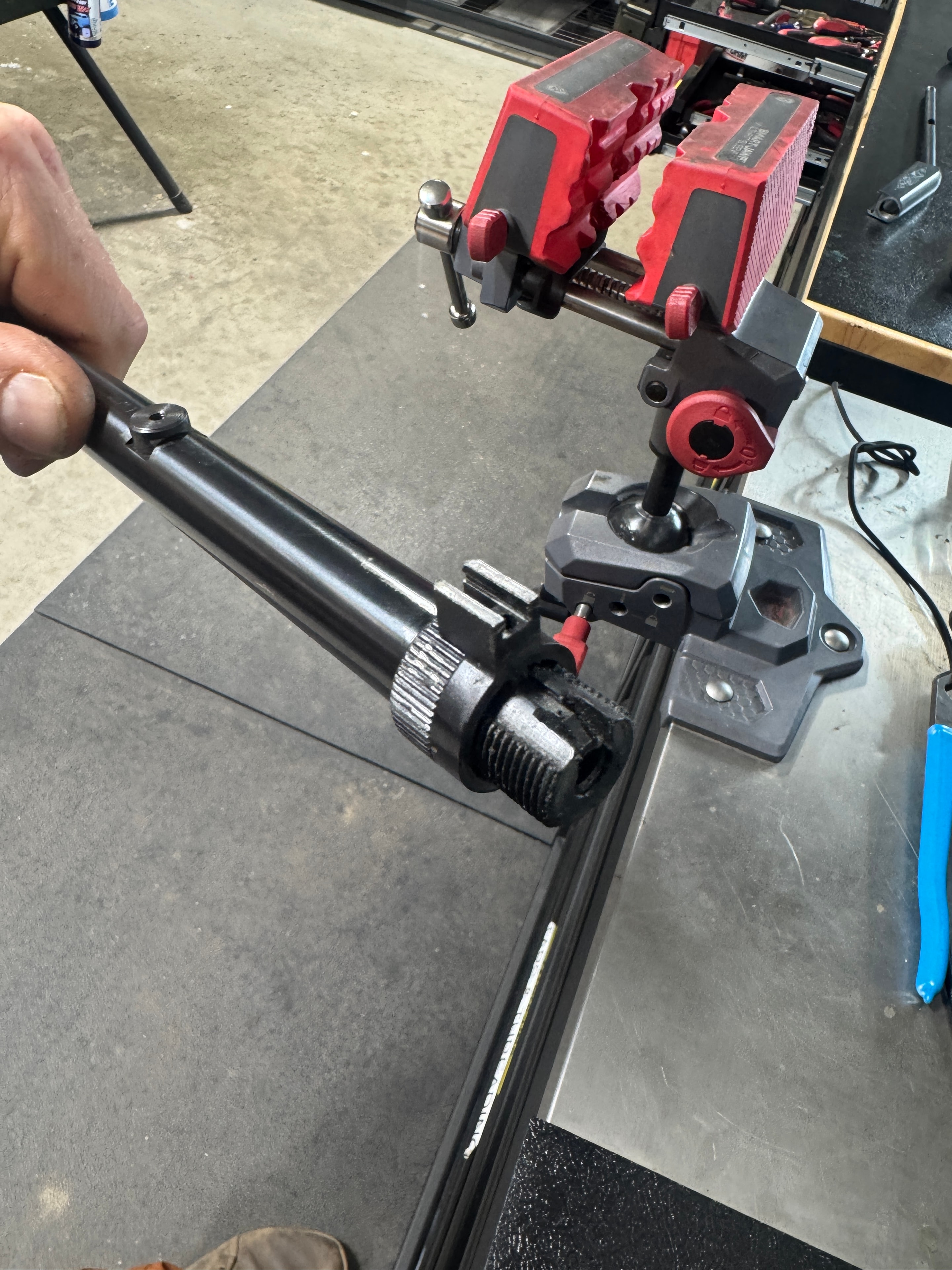 Close-up of precision pin turning on the lathe at Northwoods Firearms — custom part being machined in the four-jaw chuck