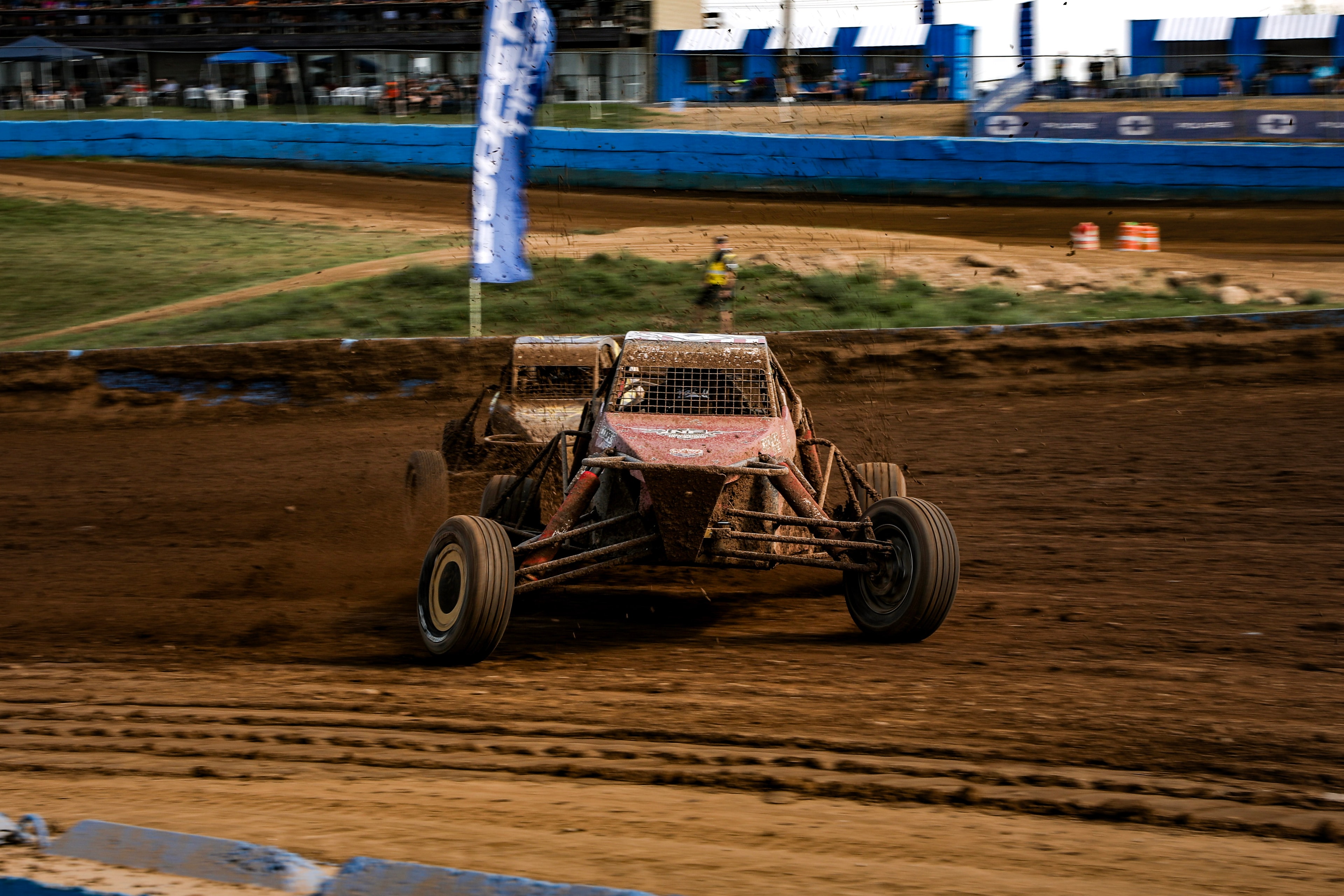 Connor #15 Northwoods Firearms Pro Buggy charging head-on through deep mud at a night race — Championship Off-Road Series